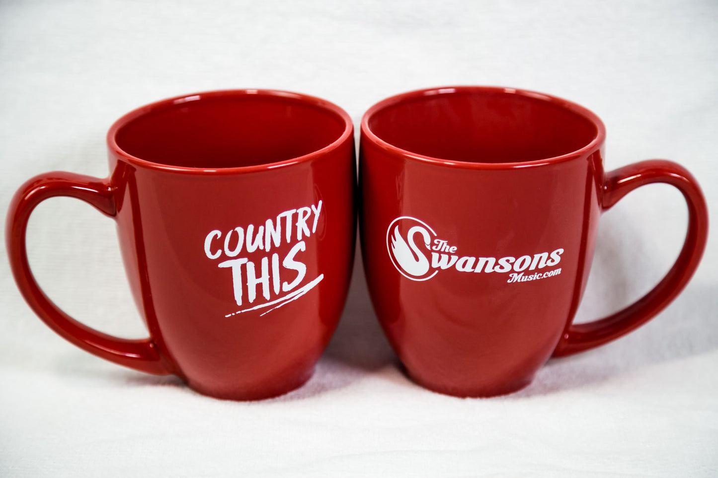 Two red mugs with the word country this on them.