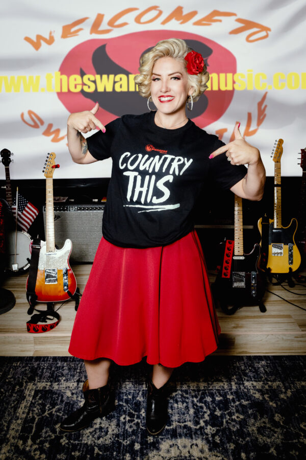 A woman wearing a Country This T-shirts adult (unisex) t-shirt.