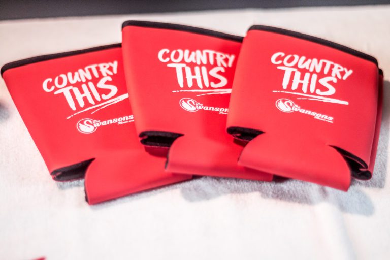 Three red koozies with the word country this on them.