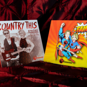 Two COMBO CD's 'Bam' & 'Country This Remastered' on a red cloth.