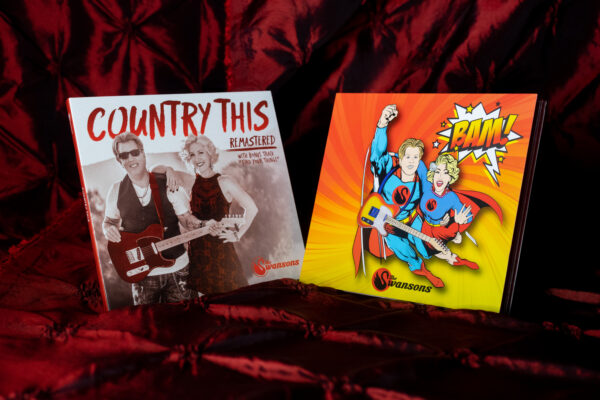 Two COMBO CD's 'Bam' & 'Country This Remastered' on a red cloth.