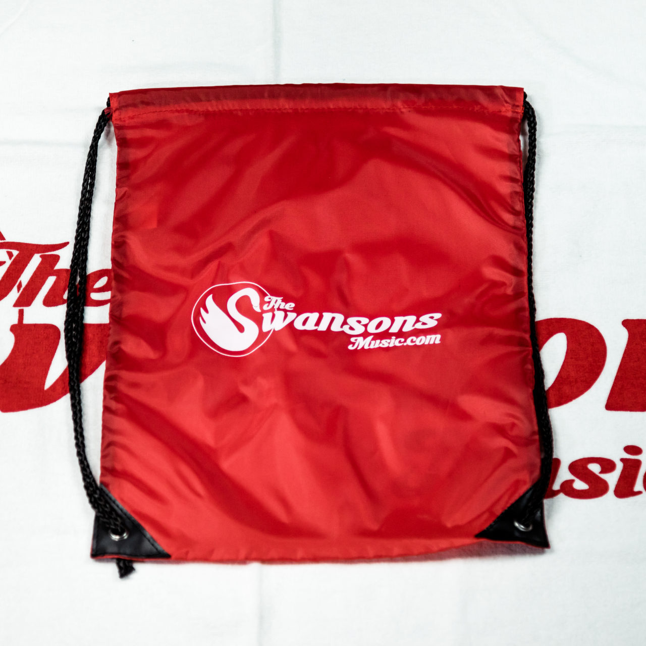 A red drawsack bag with a logo on it.